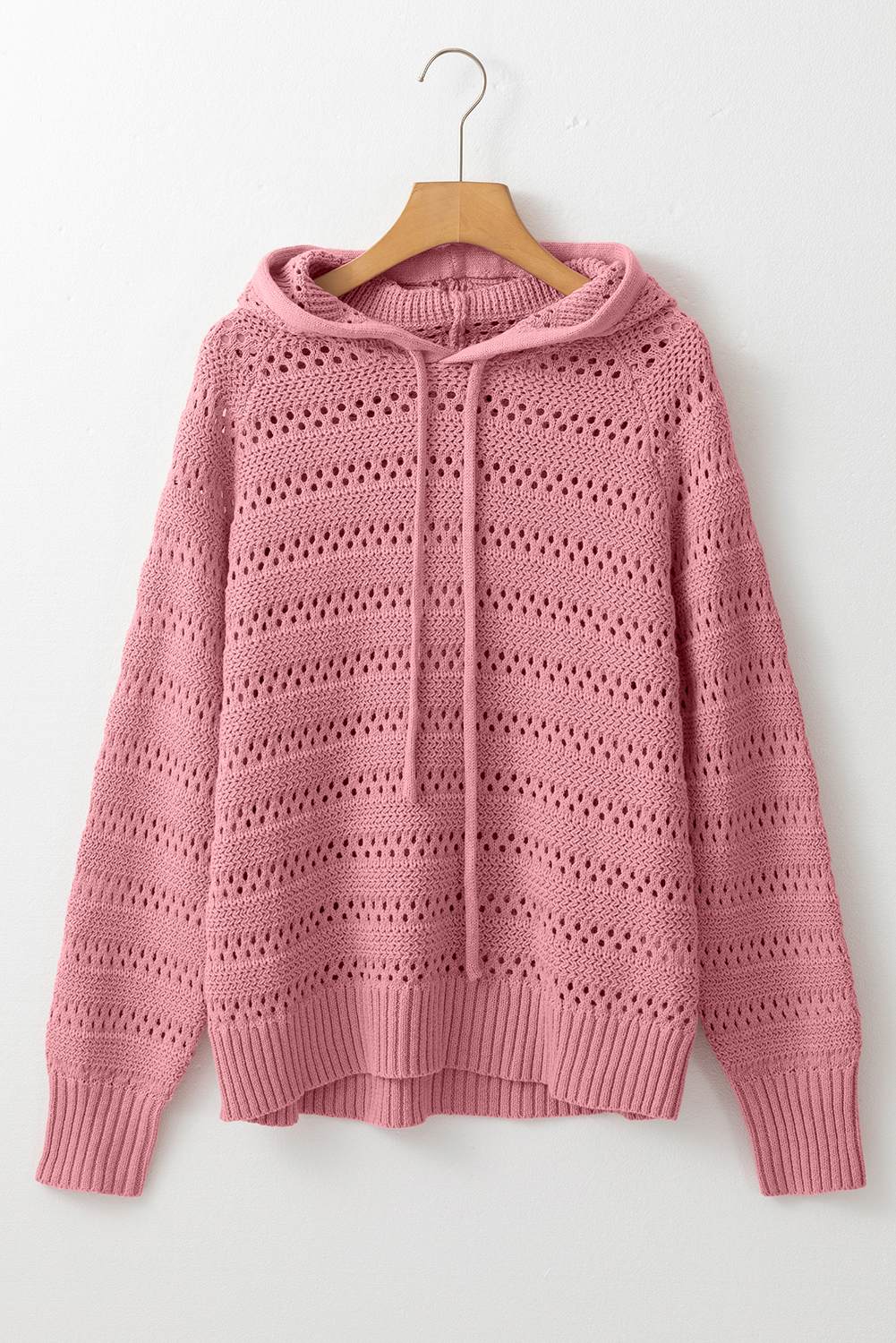 Stay warm and stylish with this Women's Peach Blossom Pointelle Knit Raglan Sleeve Hooded Sweater. The intricate pointelle knit design adds a touch of elegance, while the cozy raglan sleeves provide a comfortable and trendy touch to your outfit. The versatile hooded design with a drawstring is perfect for everyday wear, effortlessly pairing with jeans and flats for a casual look. This sweater is a must-have for a chic and comfortable ensemble, making it perfect for fall and winter seasons. Made from a soft blend of 60% cotton and 40% acrylic, this sweater ensures a cozy fit and easy care. The peach blossom color is a beautiful soft pink hue that complements most skin tones, making it a versatile addition to your wardrobe. - Detail View 4 Stay warm and stylish with this Women's Peach Blossom Pointelle Knit Raglan Sleeve Hooded Sweater. The intricate pointelle knit design adds a touch of elegance, while the cozy raglan sleeves provide a comfortable and trendy touch to your outfit. The versatile hooded design with a drawstring is perfect for everyday wear, effortlessly pairing with jeans and flats for a casual look. This sweater is a must-have for a chic and comfortable ensemble, making it perfect for fall and winter seasons. Made from a soft blend of 60% cotton and 40% acrylic, this sweater ensures a cozy fit and easy care. The peach blossom color is a beautiful soft pink hue that complements most skin tones, making it a versatile addition to your wardrobe. - Detail View 4