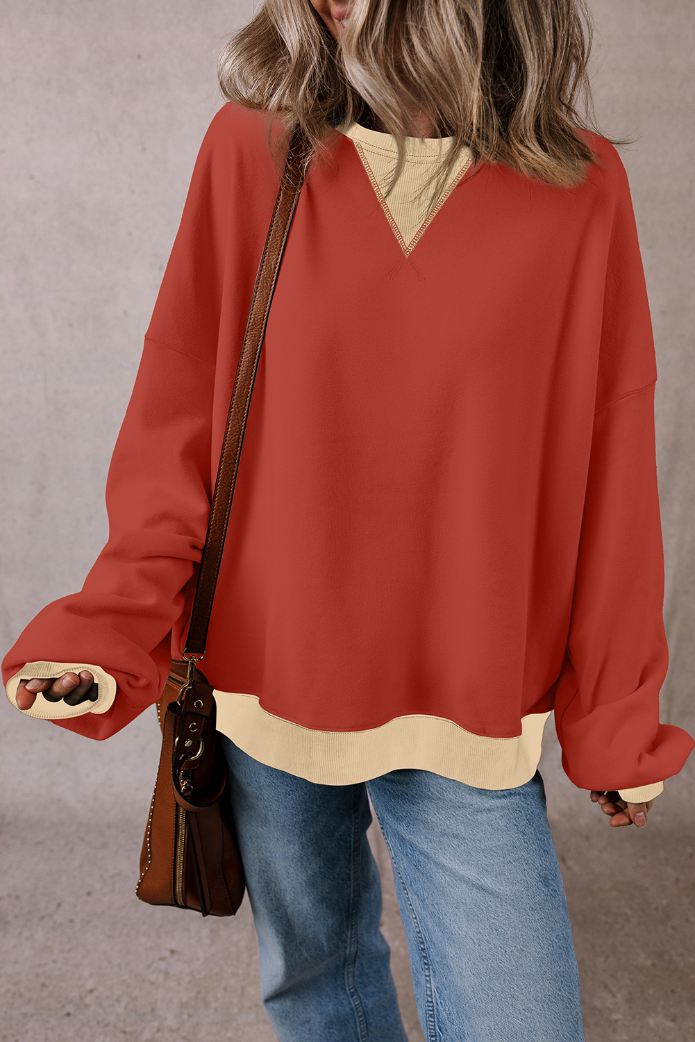 Elevate your daily fashion with this Women's Red Clay Color Block Patch Drop Shoulder Oversized Sweatshirt. Embrace the trendy oversized fit for ultimate comfort and a relaxed look. Stand out with the unique color block patchwork design, adding a touch of creativity to your outfit. The drop shoulder style enhances the casual and laid-back vibe of the sweatshirt. Made from a comfortable blend of 50% polyester and 50% cotton, this sweatshirt ensures both warmth and breathability, making it a perfect choice for the winter season. Pair it with your favorite jeans or leggings for a stylish and cozy look. Add this fashionable sweatshirt to your wardrobe for a chic and comfortable daily wear option. - Detail View 4 Elevate your daily fashion with this Women's Red Clay Color Block Patch Drop Shoulder Oversized Sweatshirt. Embrace the trendy oversized fit for ultimate comfort and a relaxed look. Stand out with the unique color block patchwork design, adding a touch of creativity to your outfit. The drop shoulder style enhances the casual and laid-back vibe of the sweatshirt. Made from a comfortable blend of 50% polyester and 50% cotton, this sweatshirt ensures both warmth and breathability, making it a perfect choice for the winter season. Pair it with your favorite jeans or leggings for a stylish and cozy look. Add this fashionable sweatshirt to your wardrobe for a chic and comfortable daily wear option. - Detail View 4