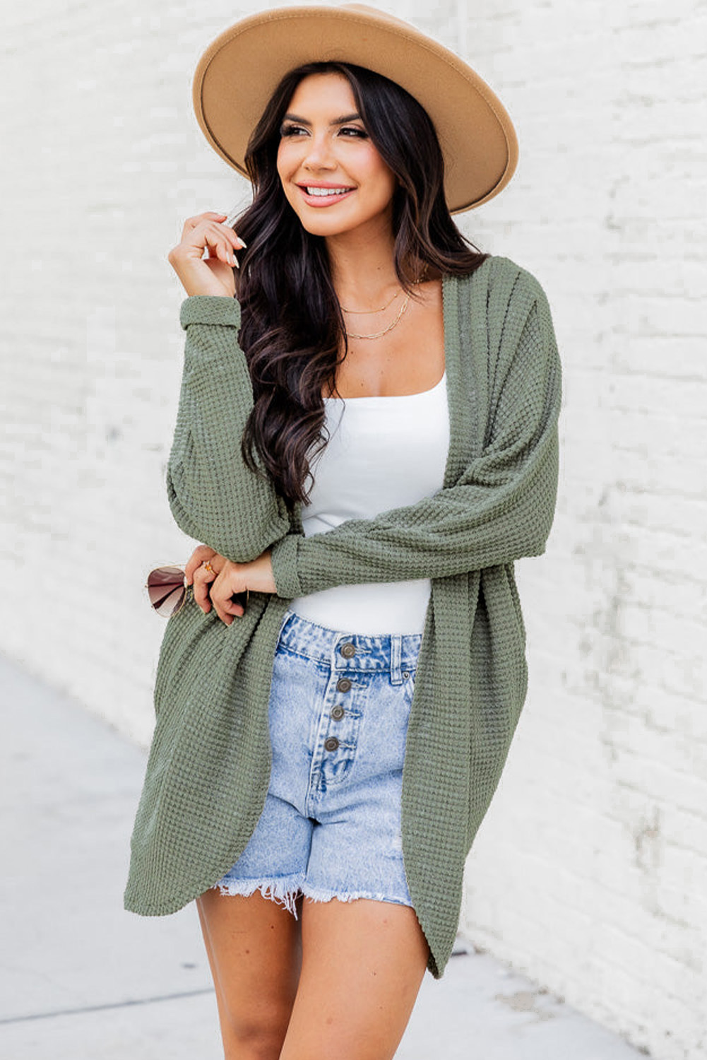 Stay cozy and stylish with this Women's Laurel Green Waffle Knit Open Front Cardigan. The soft waffle knit provides a cozy and textured look and feel, perfect for the fall and autumn seasons. The classic open front design offers versatile styling options, making it easy to layer over any outfit. The relaxed fit ensures comfort and ease of layering, while the timeless cardigan design is perfect for transitional seasons. Made from a premium blend of 95% polyester and 5% elastane, this cardigan offers durability and a comfortable fit. The Laurel Green color adds a touch of freshness to your wardrobe and effortlessly pairs with any outfit for warmth and style. With its long sleeves and convenient pockets, this cardigan is a must-have addition to your casual wardrobe. - Detail View 4 Stay cozy and stylish with this Women's Laurel Green Waffle Knit Open Front Cardigan. The soft waffle knit provides a cozy and textured look and feel, perfect for the fall and autumn seasons. The classic open front design offers versatile styling options, making it easy to layer over any outfit. The relaxed fit ensures comfort and ease of layering, while the timeless cardigan design is perfect for transitional seasons. Made from a premium blend of 95% polyester and 5% elastane, this cardigan offers durability and a comfortable fit. The Laurel Green color adds a touch of freshness to your wardrobe and effortlessly pairs with any outfit for warmth and style. With its long sleeves and convenient pockets, this cardigan is a must-have addition to your casual wardrobe. - Detail View 4