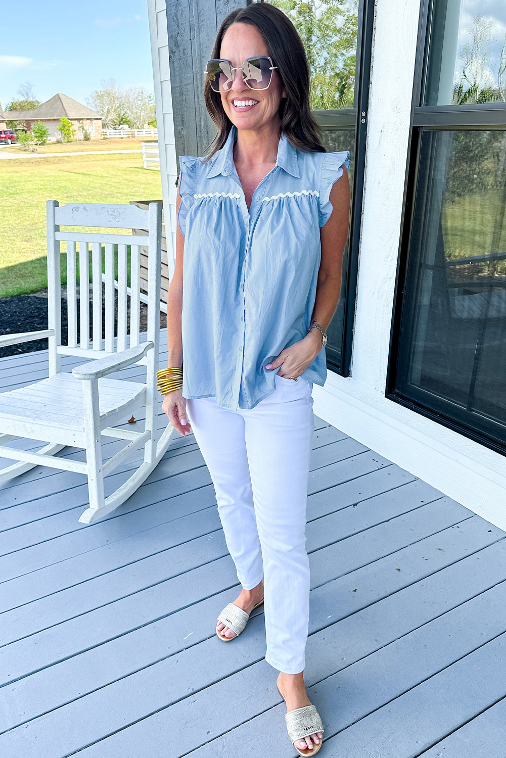 Add a touch of elegance to your daily outfits with this Women's Sleeveless Sky Blue Ric Rac Trim Frilly Shirt. This delightful blend of style and comfort features a classic spread collar and pleat detailing at the front and back, exuding timeless sophistication. The ruffles along the shoulder and armhole provide a subtle feminine touch, while the ric rac trim at the front yoke adds a unique and stylish element. Crafted from a breathable cotton blend fabric, this shirt is lightweight and airy, perfect for warm summer days. With its shift silhouette and sleeveless design, it's easy to style and pair with your favorite bottoms for a chic and effortless look. - Detail View 4 Add a touch of elegance to your daily outfits with this Women's Sleeveless Sky Blue Ric Rac Trim Frilly Shirt. This delightful blend of style and comfort features a classic spread collar and pleat detailing at the front and back, exuding timeless sophistication. The ruffles along the shoulder and armhole provide a subtle feminine touch, while the ric rac trim at the front yoke adds a unique and stylish element. Crafted from a breathable cotton blend fabric, this shirt is lightweight and airy, perfect for warm summer days. With its shift silhouette and sleeveless design, it's easy to style and pair with your favorite bottoms for a chic and effortless look. - Detail View 4