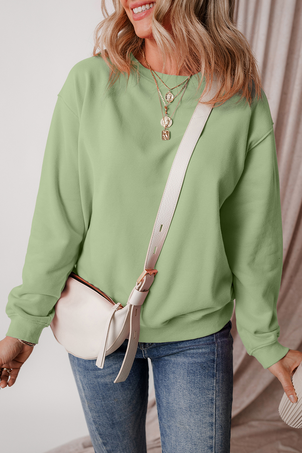 Stay warm and cozy this winter with this Women's Smoke Green Solid Drop Shoulder Fleece Lined Sweatshirt. The simple yet stylish design makes it perfect for versatile wear, while the fleece lining provides extra warmth and comfort in cold weather. The drop shoulder design adds a modern touch, making it a great addition to your winter wardrobe. The long sleeves ensure comfort and warmth, and the solid smoke green color is easy to style with your favorite jeans or leggings. This sweatshirt is a must-have for your cold weather wardrobe, featuring a comfortable and stylish design. - Detail View 4 Stay warm and cozy this winter with this Women's Smoke Green Solid Drop Shoulder Fleece Lined Sweatshirt. The simple yet stylish design makes it perfect for versatile wear, while the fleece lining provides extra warmth and comfort in cold weather. The drop shoulder design adds a modern touch, making it a great addition to your winter wardrobe. The long sleeves ensure comfort and warmth, and the solid smoke green color is easy to style with your favorite jeans or leggings. This sweatshirt is a must-have for your cold weather wardrobe, featuring a comfortable and stylish design. - Detail View 4