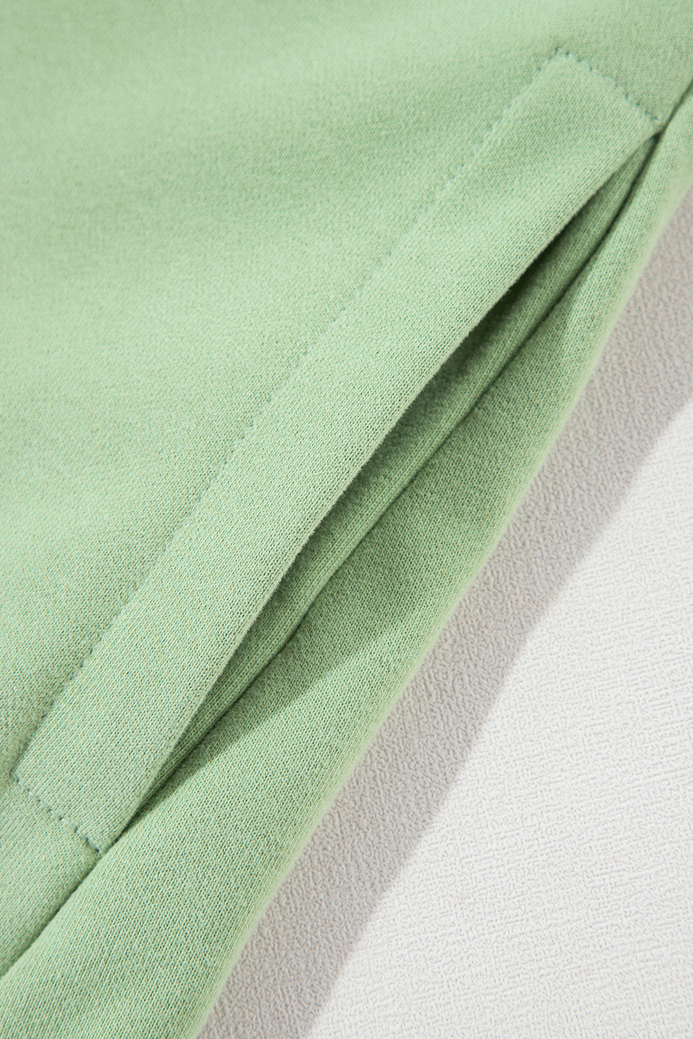 Indulge in the comfort and warmth of this Grass Green Fleece Lined Drop Shoulder High Low Sweatshirt. The luxurious soft fleece lining envelops you in warmth, while the fashionable drop shoulder design adds a relaxed and trendy touch. The high-low hem adds a modern twist to this pullover, perfect for everyday wear. The concise style makes it a versatile piece that can be easily matched with any bottoms. This sweatshirt is a must-have for any wardrobe, offering both comfort and style. - Detail View 9 Indulge in the comfort and warmth of this Grass Green Fleece Lined Drop Shoulder High Low Sweatshirt. The luxurious soft fleece lining envelops you in warmth, while the fashionable drop shoulder design adds a relaxed and trendy touch. The high-low hem adds a modern twist to this pullover, perfect for everyday wear. The concise style makes it a versatile piece that can be easily matched with any bottoms. This sweatshirt is a must-have for any wardrobe, offering both comfort and style. - Detail View 9