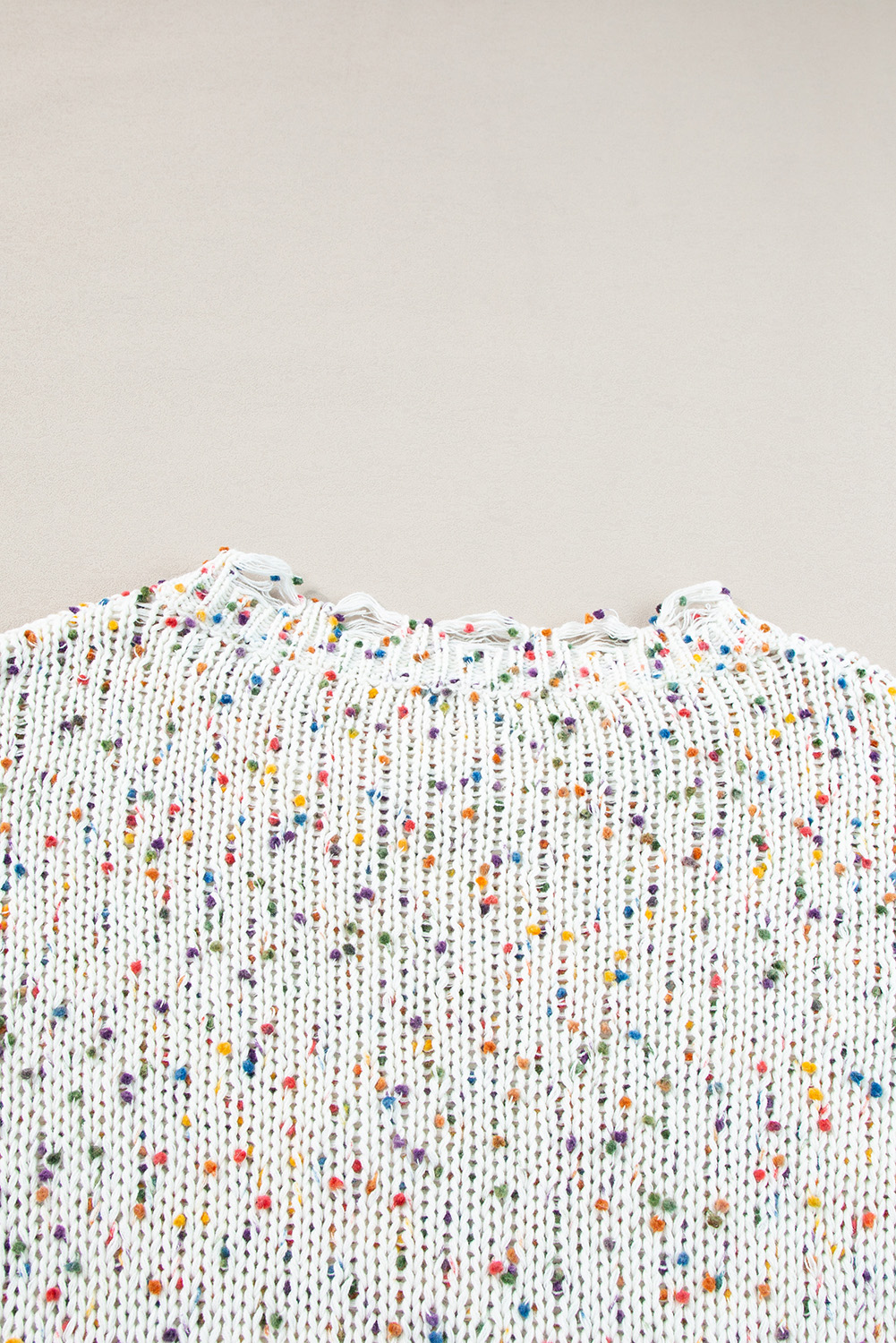 Slay all season long in our Women's White Colorful Confetti Distressed Knit Sweater. This stylish sweater features a colorful confetti knit silhouette with ribbed texturing, adding a playful and trendy touch to your winter wardrobe. The rounded neckline can be worn off one shoulder for a chic and fashionable look. The relaxed silhouette falls into an uneven hemline with distressed detailing, giving it a unique and edgy vibe. Made from premium 100% polyester, this sweater ensures warmth and comfort during the colder months. The multicolor damain print pattern adds a pop of color and personality to your outfit. Pair this sweater with distressed ankle skinnies for a trendy and casual ensemble that will turn heads. Embrace the winter season in style with this fashionable and comfortable sweater. - Detail View 9 Slay all season long in our Women's White Colorful Confetti Distressed Knit Sweater. This stylish sweater features a colorful confetti knit silhouette with ribbed texturing, adding a playful and trendy touch to your winter wardrobe. The rounded neckline can be worn off one shoulder for a chic and fashionable look. The relaxed silhouette falls into an uneven hemline with distressed detailing, giving it a unique and edgy vibe. Made from premium 100% polyester, this sweater ensures warmth and comfort during the colder months. The multicolor damain print pattern adds a pop of color and personality to your outfit. Pair this sweater with distressed ankle skinnies for a trendy and casual ensemble that will turn heads. Embrace the winter season in style with this fashionable and comfortable sweater. - Detail View 9