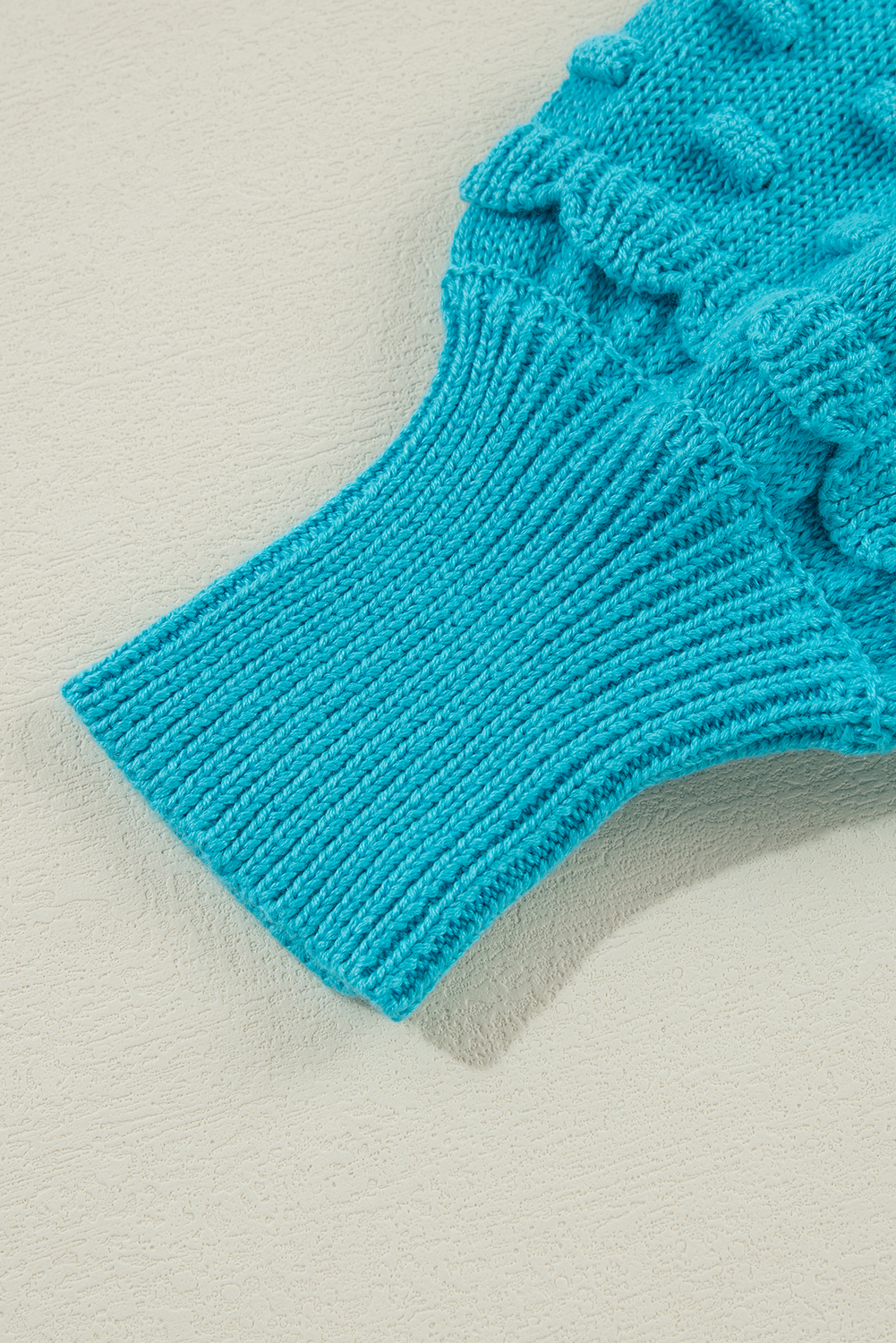 Add a touch of elegance to your wardrobe with this Women's Turquoise Ruffled Eyelet Bubble Sleeve Sweater. The unique eyelet bubble sleeves with ruffled detail create a striking look, while the snug fit style ensures a comfortable fit. This knit top is perfect for both dressy and casual occasions, and can be paired with most bottoms to match with your personal style. Made from a comfortable blend of 55% acrylic and 45% cotton, this sweater is a great addition to your fall and autumn wardrobe. With its chic and stylish design, it's sure to be a favorite in your closet. - Detail View 9 Add a touch of elegance to your wardrobe with this Women's Turquoise Ruffled Eyelet Bubble Sleeve Sweater. The unique eyelet bubble sleeves with ruffled detail create a striking look, while the snug fit style ensures a comfortable fit. This knit top is perfect for both dressy and casual occasions, and can be paired with most bottoms to match with your personal style. Made from a comfortable blend of 55% acrylic and 45% cotton, this sweater is a great addition to your fall and autumn wardrobe. With its chic and stylish design, it's sure to be a favorite in your closet. - Detail View 9