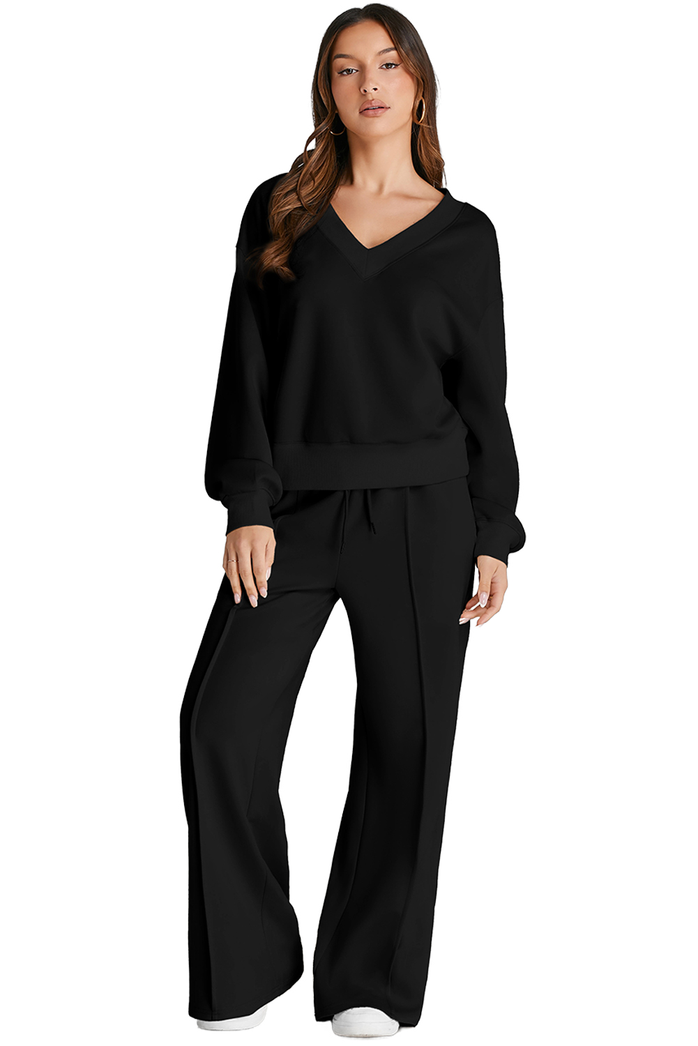 Stay comfortable and trendy during your workouts with this Women's Black V-Neck Cropped Seamed High-Waist Sports Set. The solid black set includes a cropped top and high-waist pants, ensuring a stylish and coordinated look. Easily adjust the fit of the pants with the drawstring on the waist, providing flexibility and comfort during exercise. The long sleeves and V-neck design add a touch of style to the set, making it suitable for outdoor activities and daily wear. Made from a soft blend of 50% polyester, 45% viscose, and 5% elastane, this set offers comfort and breathability. The versatile design makes it perfect for pairing with sneakers for sports or casual outings. Stay fashionable and comfortable with this must-have activewear set for the winter season. - Detail View 9 Stay comfortable and trendy during your workouts with this Women's Black V-Neck Cropped Seamed High-Waist Sports Set. The solid black set includes a cropped top and high-waist pants, ensuring a stylish and coordinated look. Easily adjust the fit of the pants with the drawstring on the waist, providing flexibility and comfort during exercise. The long sleeves and V-neck design add a touch of style to the set, making it suitable for outdoor activities and daily wear. Made from a soft blend of 50% polyester, 45% viscose, and 5% elastane, this set offers comfort and breathability. The versatile design makes it perfect for pairing with sneakers for sports or casual outings. Stay fashionable and comfortable with this must-have activewear set for the winter season. - Detail View 9