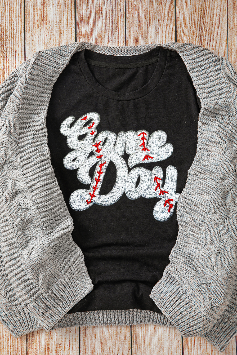 Showcase your team pride with this dazzling Women's Black Sequin Game Day Graphic Crew Neck Tee. The sequined graphics add a touch of excitement to your everyday outfit, making it perfect for game day or casual outings. The classic crew neck design and short sleeves provide a comfortable fit, while the polyester, cotton, and elastane blend ensures durability and ease of movement. Pair it with jeans or athletic wear for a stylish ensemble that's perfect for wearing game after game. Whether you're cheering on your favorite team or just want to add some personality to your daily look, this graphic tee is a must-have for any sports fan. - Detail View 4 Showcase your team pride with this dazzling Women's Black Sequin Game Day Graphic Crew Neck Tee. The sequined graphics add a touch of excitement to your everyday outfit, making it perfect for game day or casual outings. The classic crew neck design and short sleeves provide a comfortable fit, while the polyester, cotton, and elastane blend ensures durability and ease of movement. Pair it with jeans or athletic wear for a stylish ensemble that's perfect for wearing game after game. Whether you're cheering on your favorite team or just want to add some personality to your daily look, this graphic tee is a must-have for any sports fan. - Detail View 4