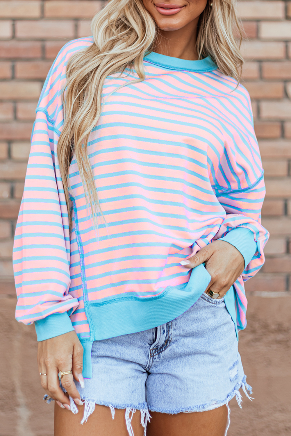 Add a touch of modernity and trendiness to your wardrobe with this Women's Pink Stripe Contrast Trim High-Low Pullover Tunic Sweatshirt. The stylish contrast trim detailing adds a pop of color and style, making it a standout piece in your collection. Designed with a flattering tunic length, this sweatshirt offers a versatile and comfortable fit, perfect for daily wear. The classic crew neck design provides a timeless and casual appeal, suitable for various occasions. Made from a premium blend of 70% polyester, 25% cotton, and 5% elastane, this sweatshirt ensures both comfort and durability. The pink stripe pattern and colorblock details exude a chic and fashionable vibe, elevating your personal style effortlessly. Pair it with your favorite jeans or leggings for a cozy and stylish look in the fall and autumn season. - Detail View 9 Add a touch of modernity and trendiness to your wardrobe with this Women's Pink Stripe Contrast Trim High-Low Pullover Tunic Sweatshirt. The stylish contrast trim detailing adds a pop of color and style, making it a standout piece in your collection. Designed with a flattering tunic length, this sweatshirt offers a versatile and comfortable fit, perfect for daily wear. The classic crew neck design provides a timeless and casual appeal, suitable for various occasions. Made from a premium blend of 70% polyester, 25% cotton, and 5% elastane, this sweatshirt ensures both comfort and durability. The pink stripe pattern and colorblock details exude a chic and fashionable vibe, elevating your personal style effortlessly. Pair it with your favorite jeans or leggings for a cozy and stylish look in the fall and autumn season. - Detail View 9